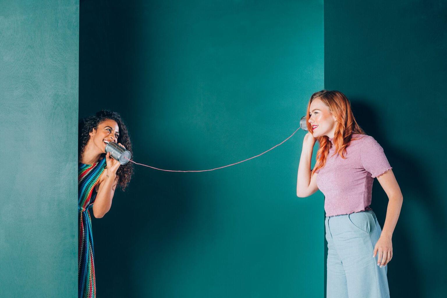 Two women holding phones