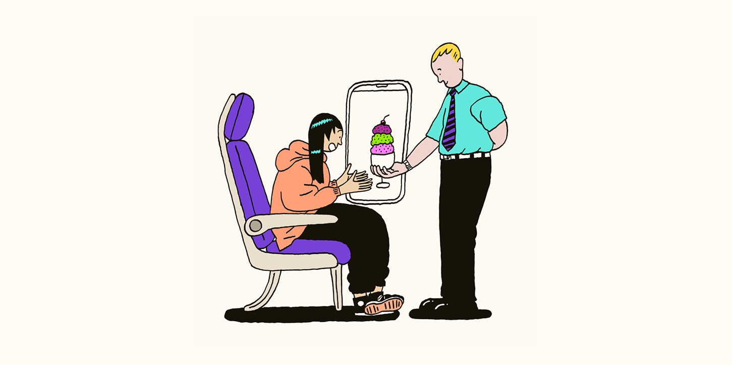 A man hands ice cream to a woman on a plane.