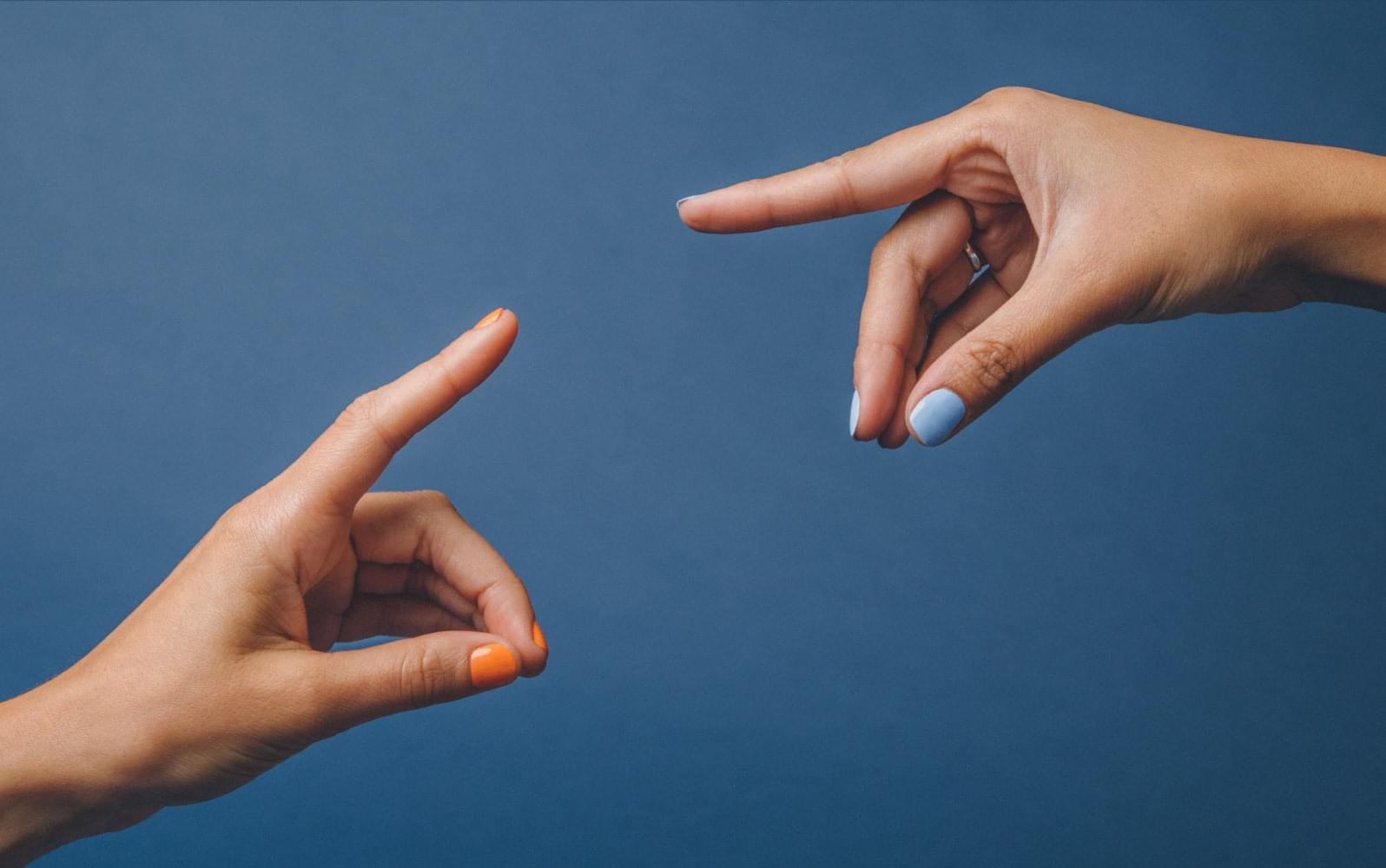 Hands pointing on a blue background