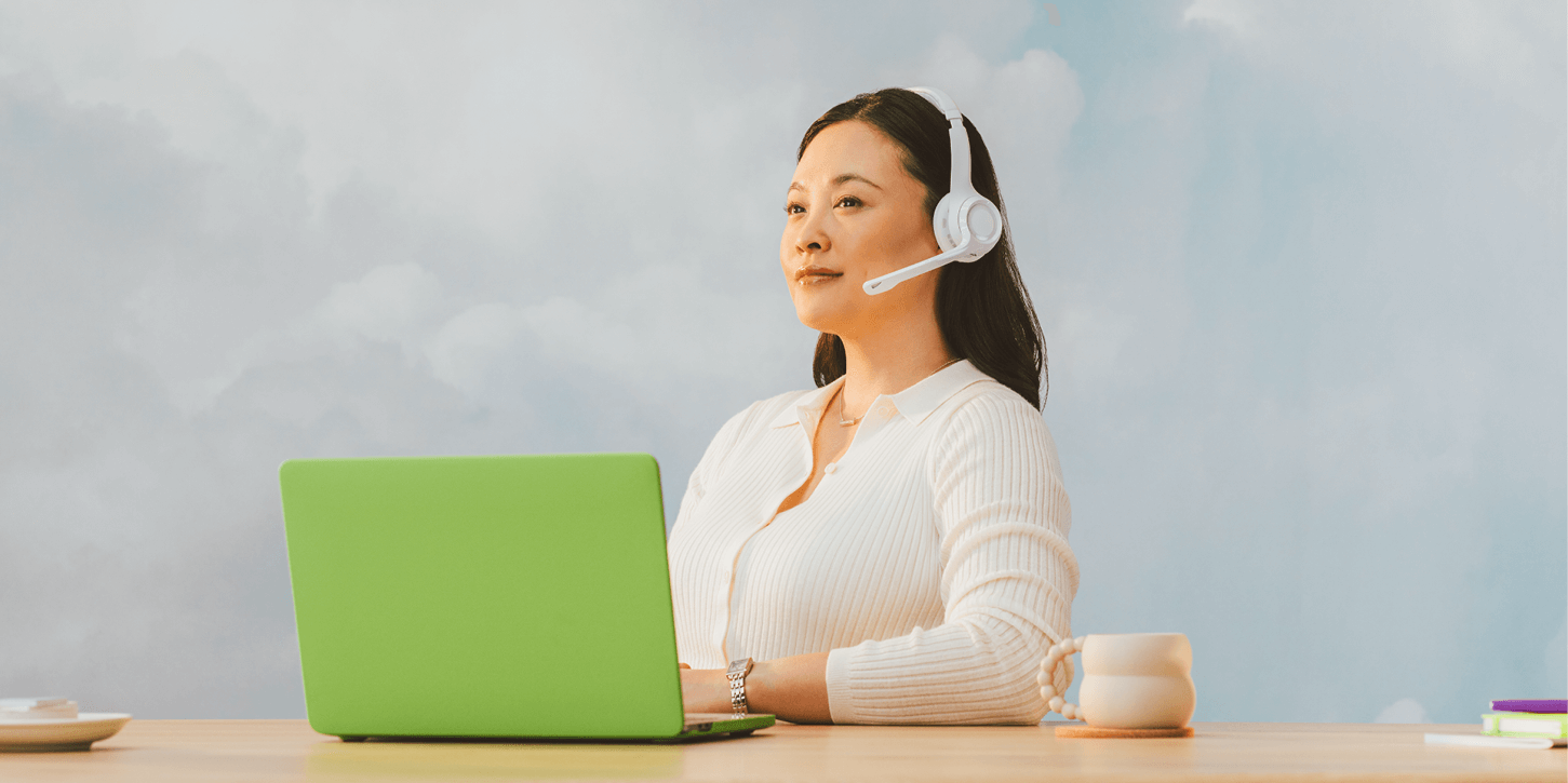 An agent with a headset and laptop using “happy to help” synonyms and alternatives.