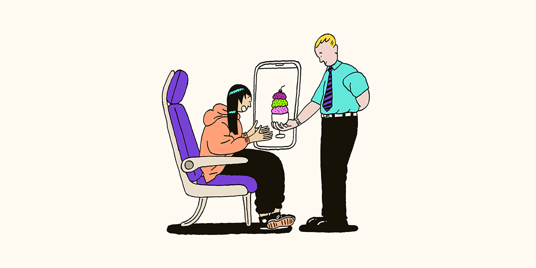 A flight attendant gauges customer intent while serving a passenger a sundae to enhance their onboard experience.