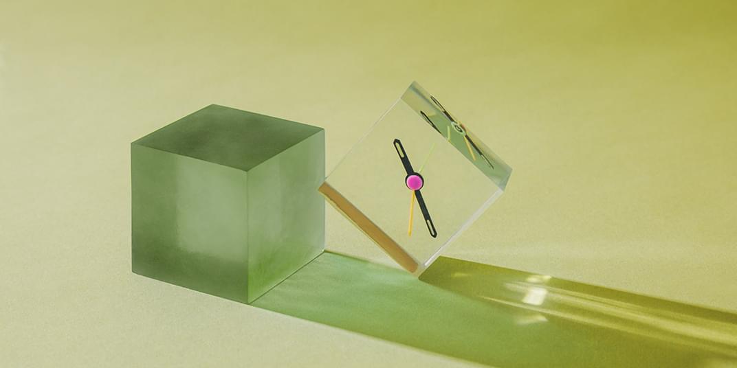 An image shows green cubes and clock parts, representing AI-powered ticketing automation.