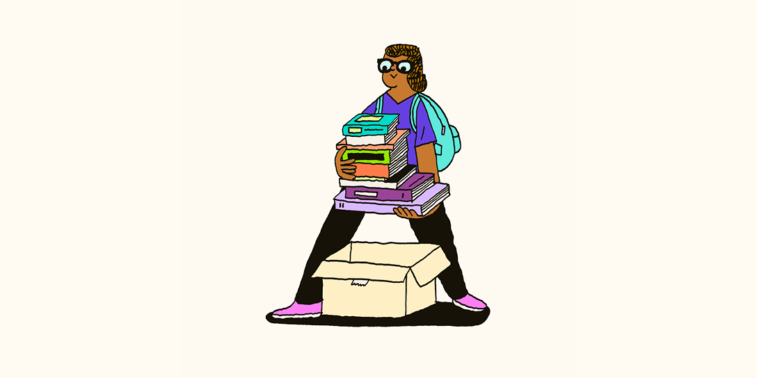 A girl with glasses wearing a backpack lifts a multicolored pile of books out of a cardboard box.