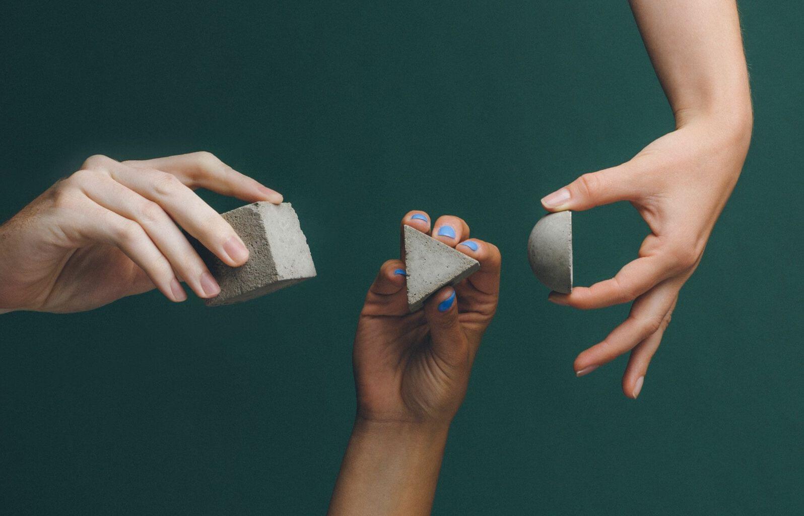 Key components of a sales proposal, hands holding different shapes