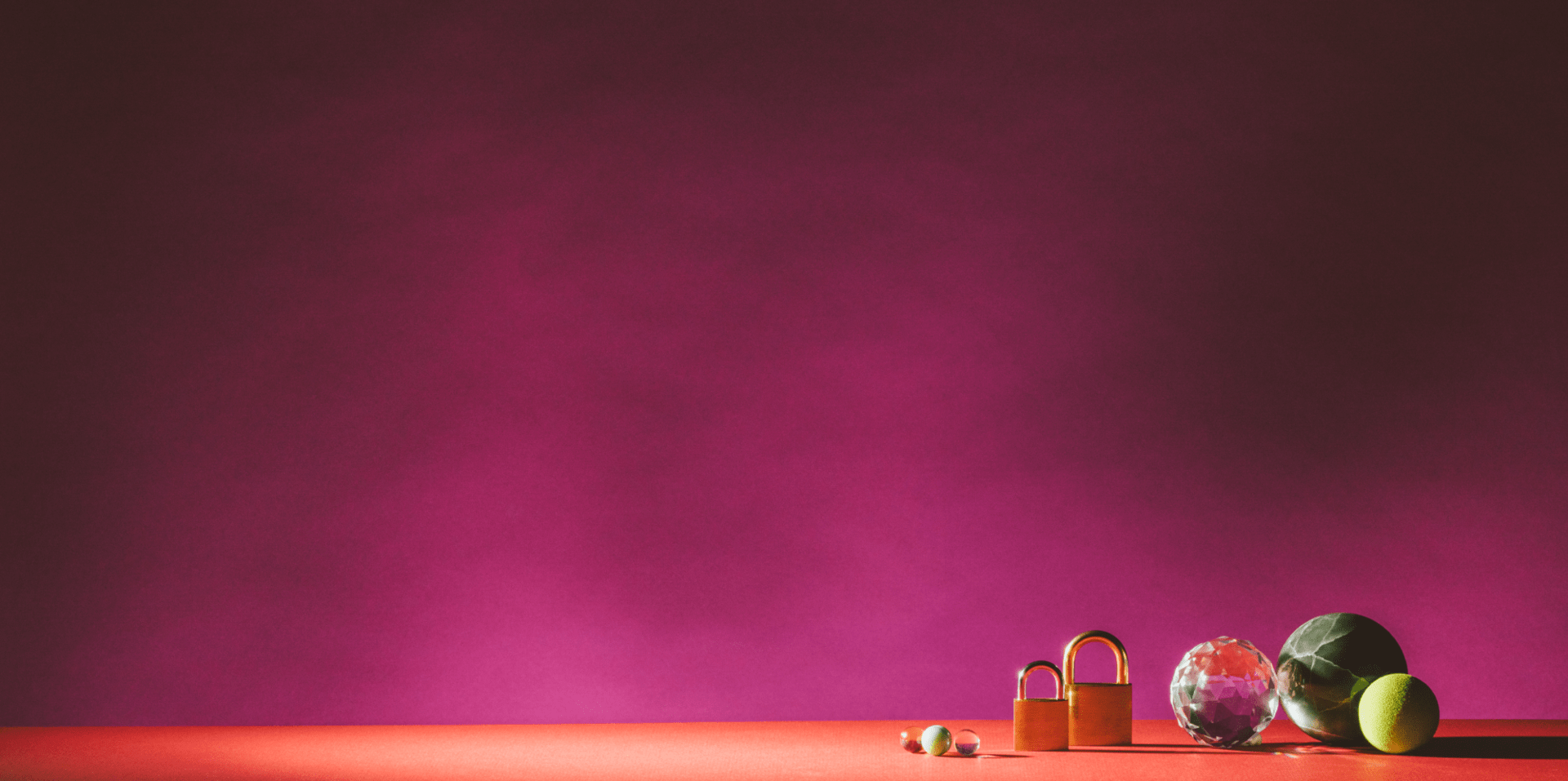 abstract art of circular objects and two locks in front of a pink background