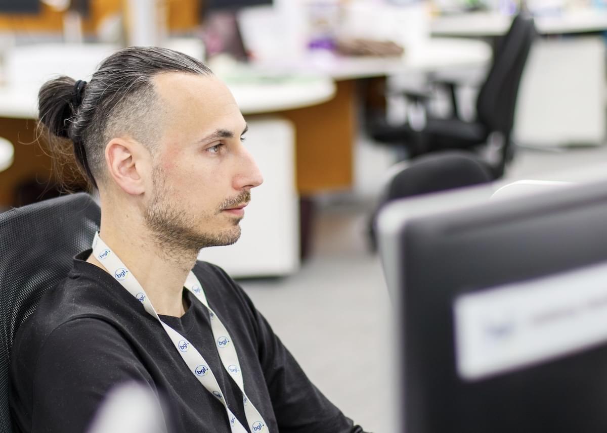A A BGL employee works on a computer in an office