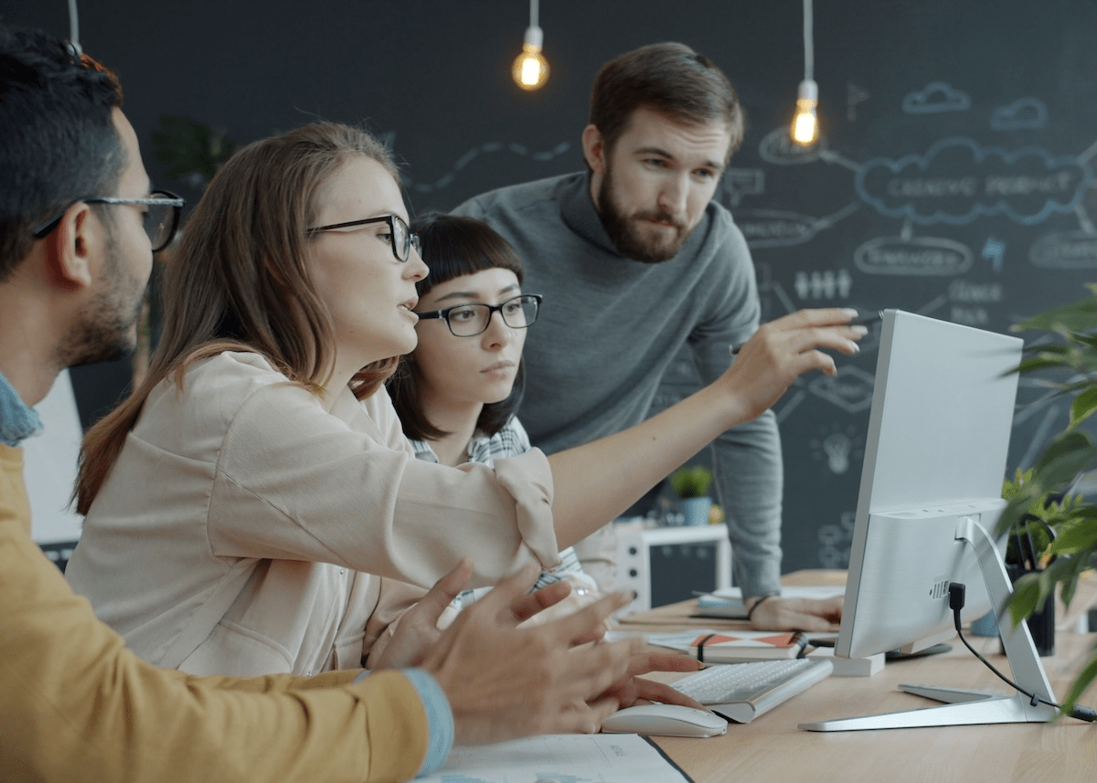 Capture team members at work in front of a computer