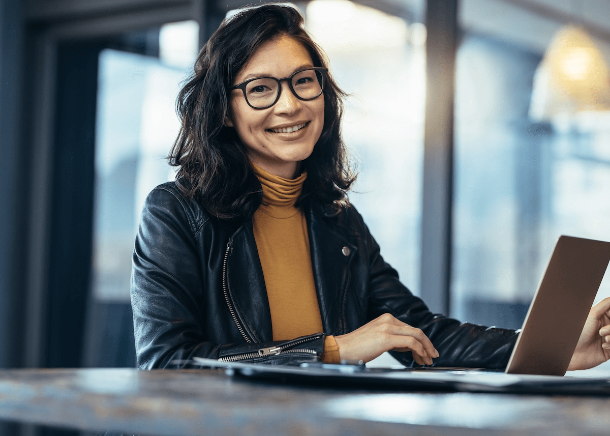 Smiling woman, working at computer