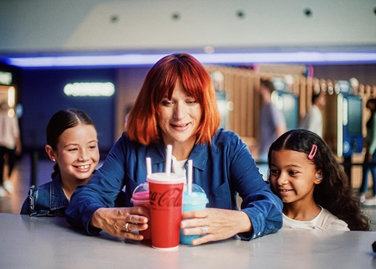 A woman with two young children purchase snacks at ODEON Cinemas.