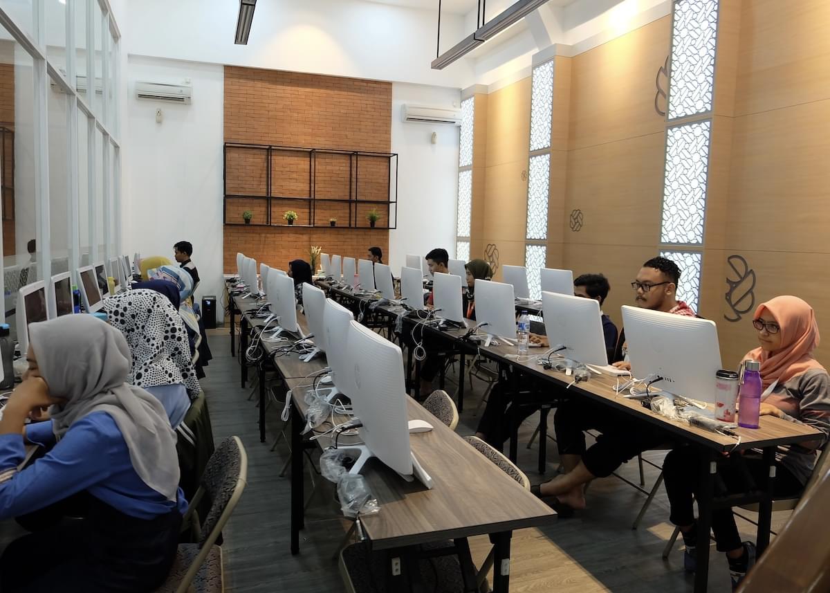 Employees working on a fleet of computers inside Privy's office