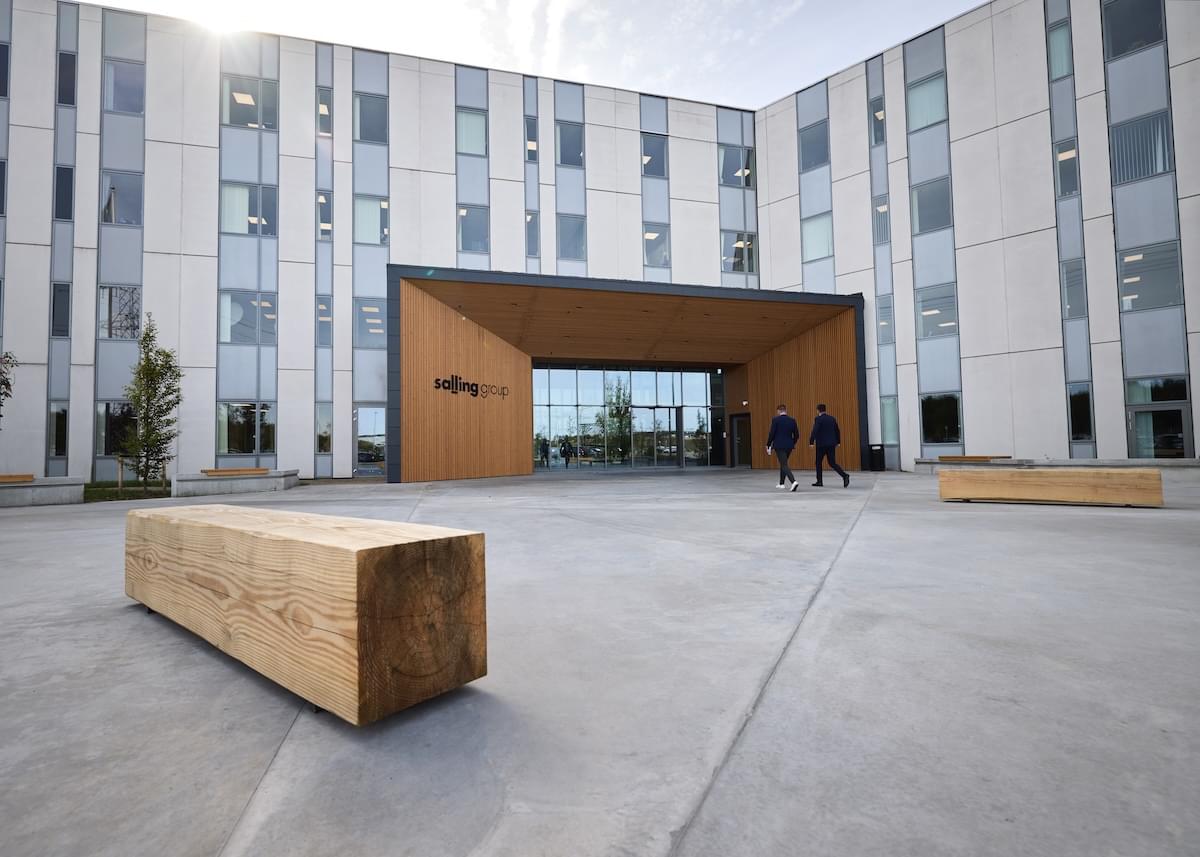 Exterior of the courtyard Salling Group headquarters with modern wooden bench and entryway