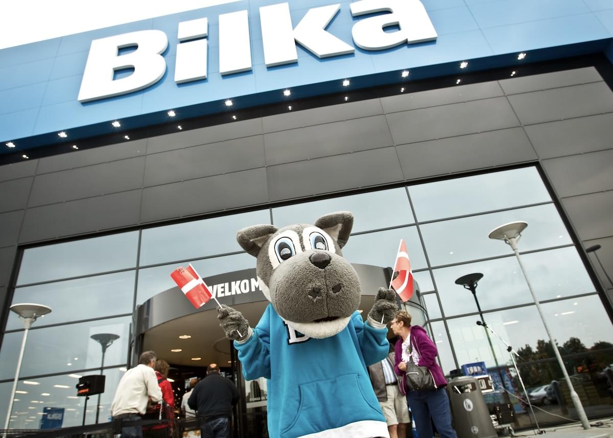 Exterior of Bilka with the store's mascot, Billy the Wolf, waving two tiny Danish flags