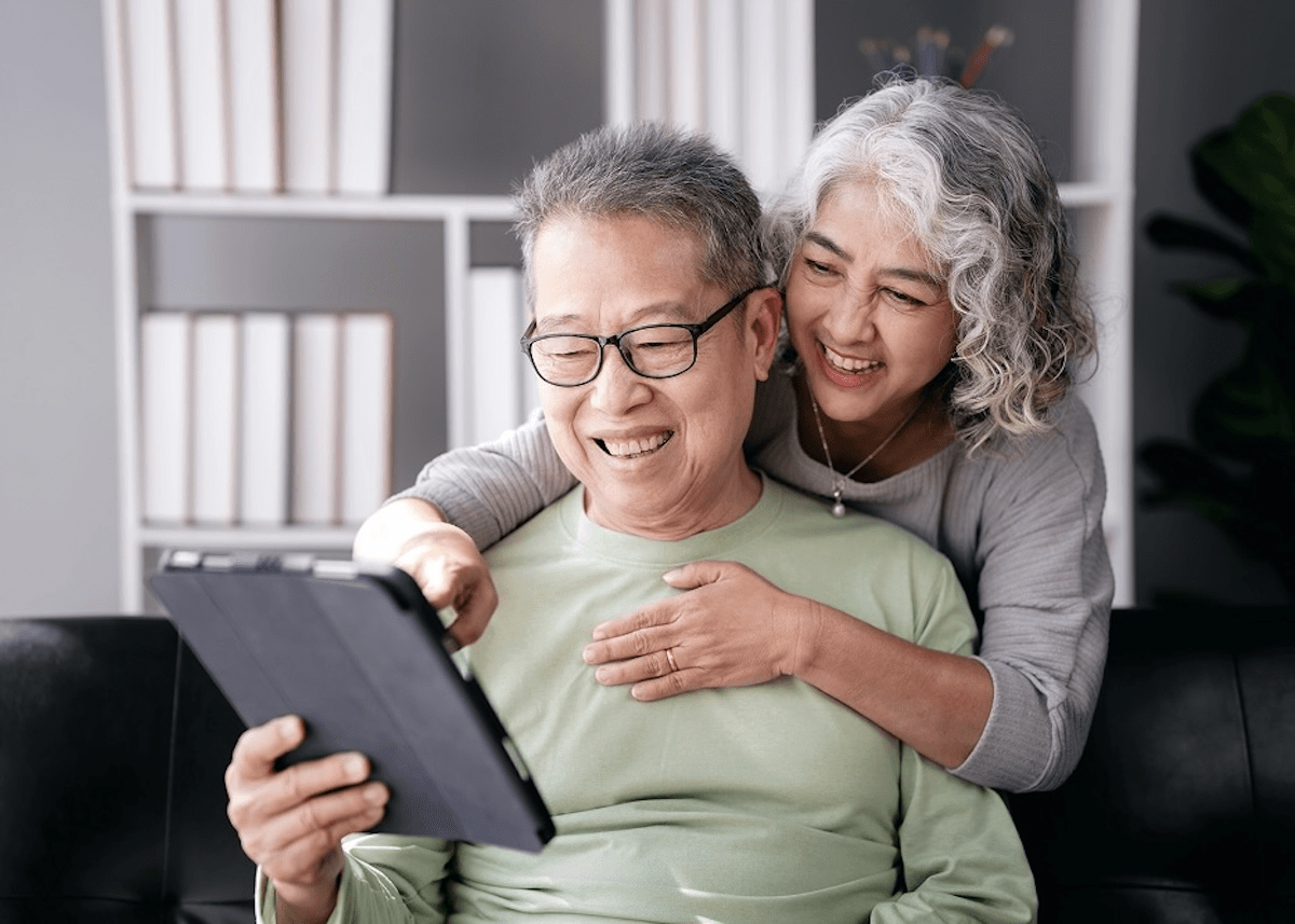 An older couple chooses new frames from XP Health on their iPad